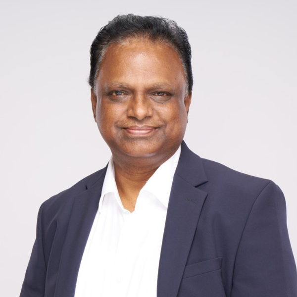 Velusamy smiling into the camera.